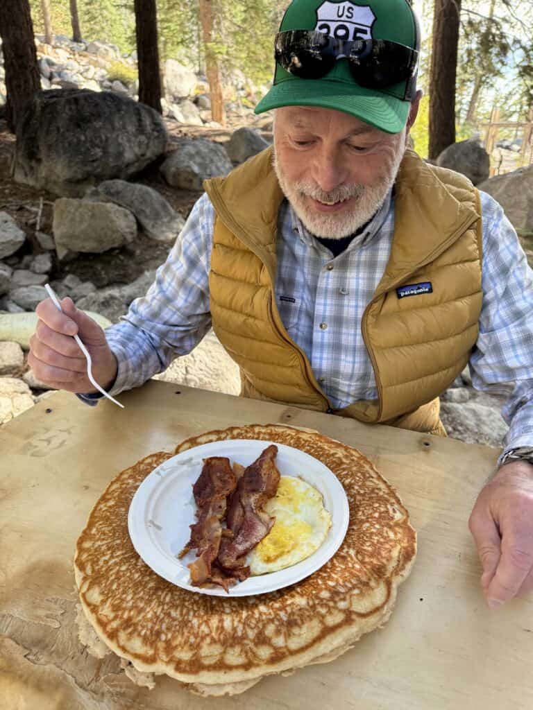 Man about to eat giant pancake at Whitney Portal Store near Lone Pine, California.