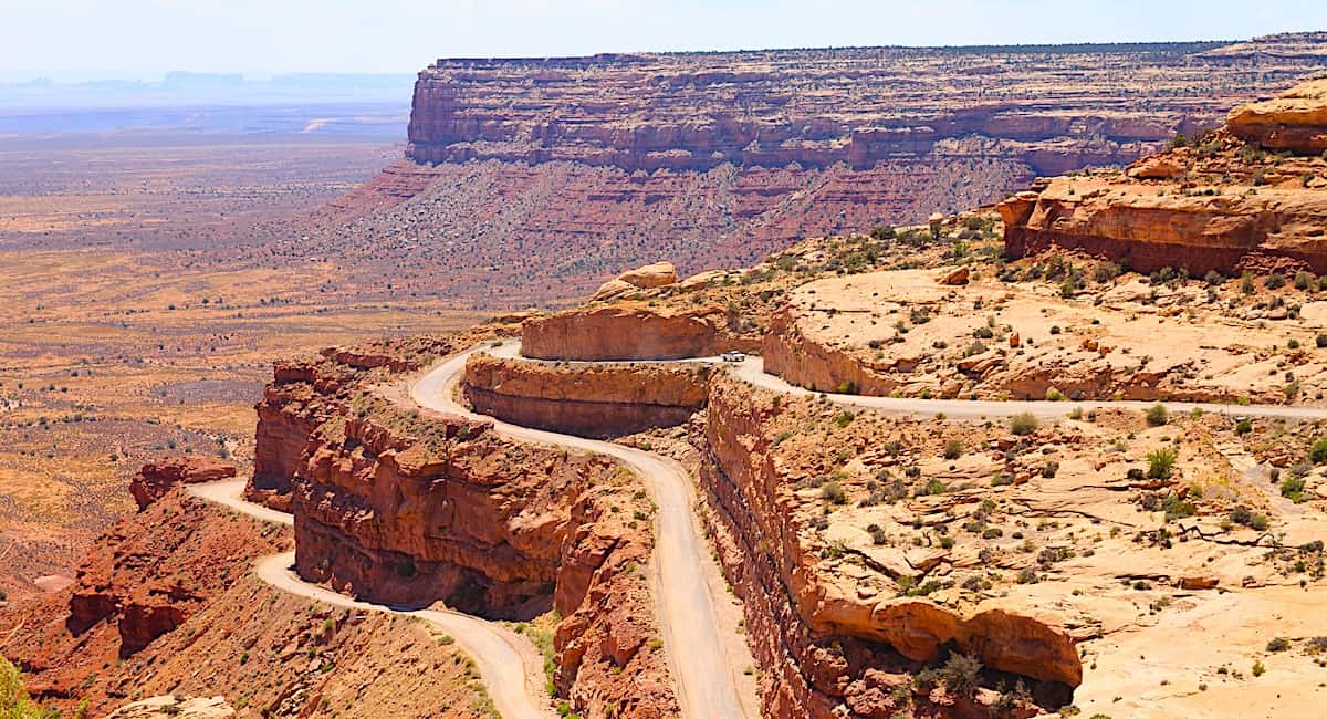 a steep road carved into the side of Cedar Mesa with numerous hairpin turns