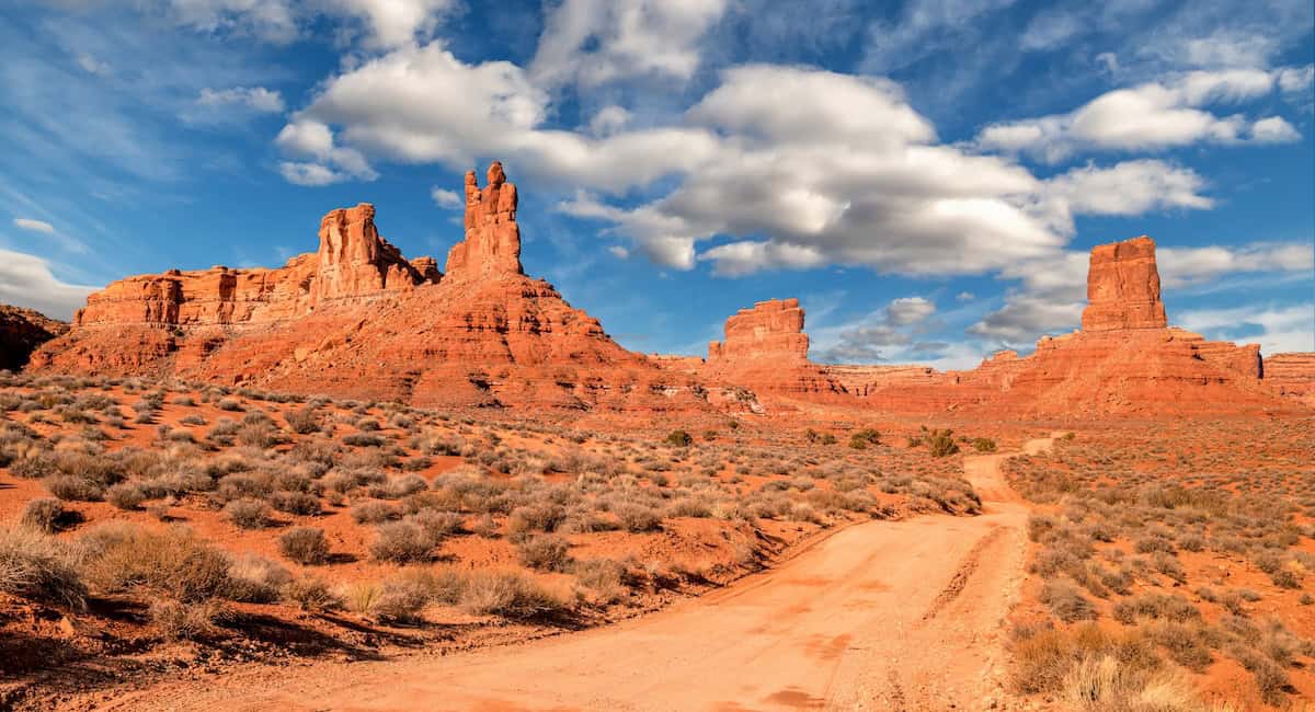 Red sandstone rock formations along a dirt road in Valley of the Gods in southeast Utah