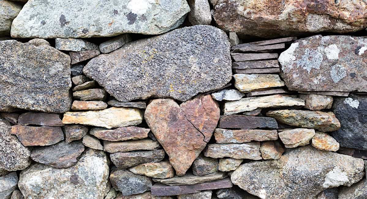 heart shaped rock in a rock wall